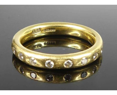 A contemporary 18ct yellow gold diamond eternity ring by Paul Spurgeon, arranged as 18 brilliants in a continuous rubover set