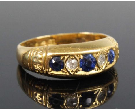 An 18ct yellow gold, sapphire and diamond half hoop ring, featuring three graduated round sapphires alternating with two Old 