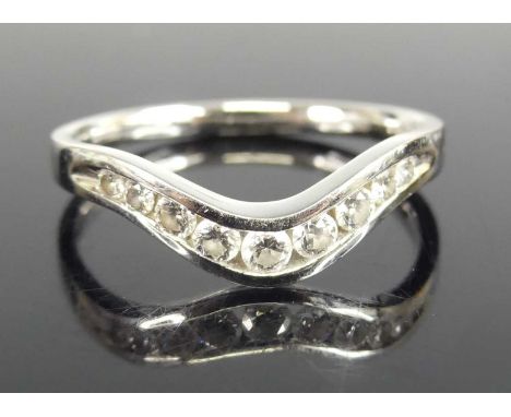 A platinum diamond wishbone style half hoop ring comprising 9 round brilliant cut diamonds in channel settings. Diamond diame