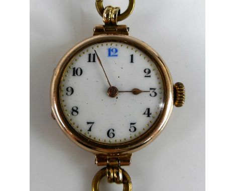 A vintage lady's 9ct gold cased wristwatch, having an unsigned white enamel dial with Arabic numerals, manual wind movement, 