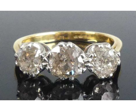 A yellow and white metal diamond three-stone ring, featuring three graduated old cut diamonds in claw settings, diamond dimen