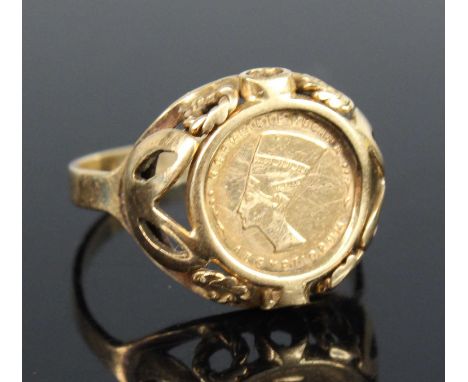 A lady's yellow metal signet ring, set with a small Egyptian coin, stamped 585 and tests as approx 14ct gold, 2.4g, size K