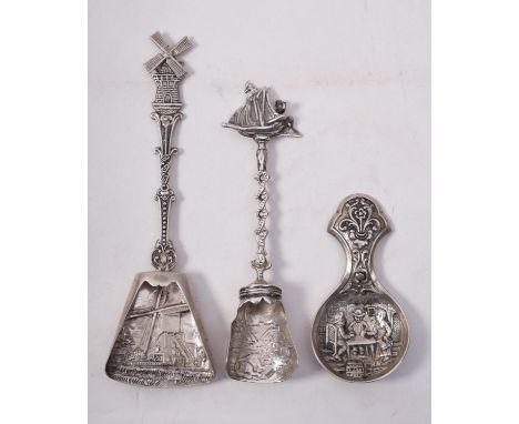 Three Dutch silver caddy spoons, with embossed and shaped bowls with windmill and ship terminals (3).

