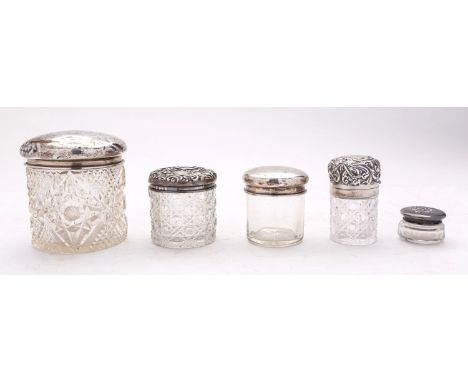 A silver topped bottle and four silver topped dressing table jars,59g gross (5)