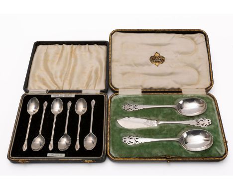 A set of silver coffee spoons and a cased three piece christening set. 