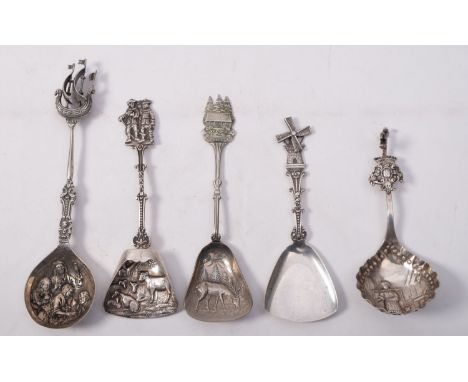 A collection of five Dutch silver and silver plated caddy spoons, with embossed and shaped bowls with assorted figural, windm