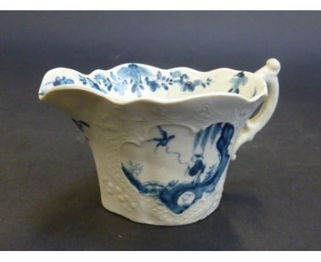 A WORCESTER FIRST PERIOD MOULDED CREAM BOAT, circa 1755-58, of lobed oval shape with scroll handle, the sides moulded with ro