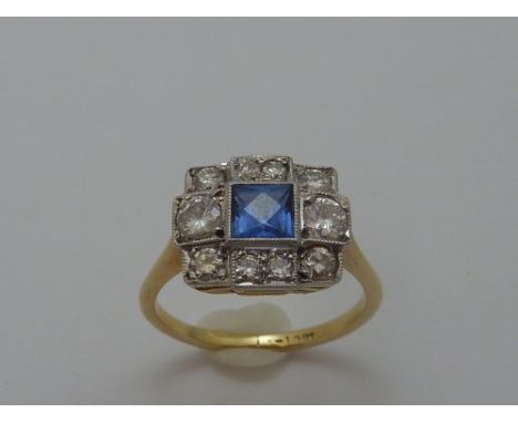 A SAPPHIRE AND DIAMOND ART DECO STYLE RING, with square shape cornflower blue sapphire within a square-shape surround with br