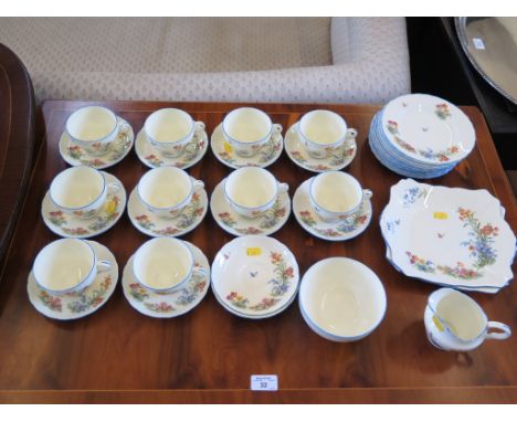 A Tuscan China part tea service with flower and butterfly pattern and blue edge (38 pieces)