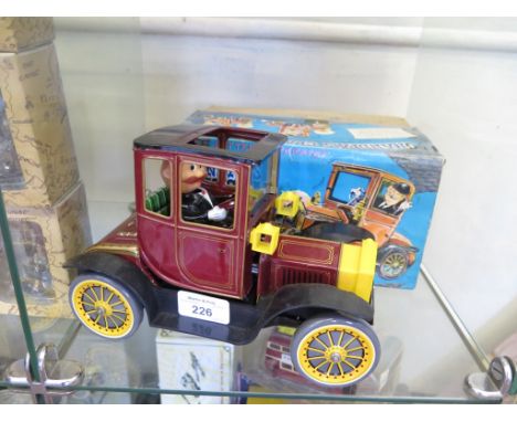 A Japanese Nomura tinplate 'Grandpa's Classic Car' toy, battery operated with shaking action and protruding engine, with orig