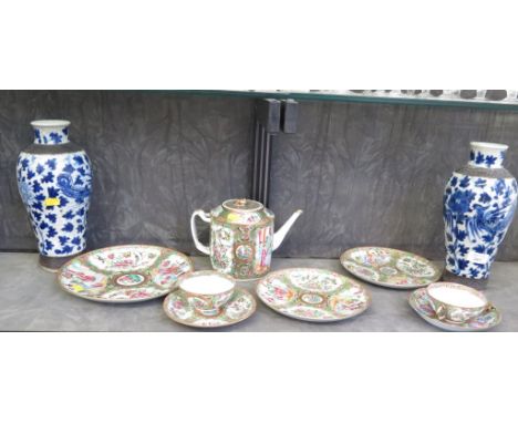 A Chinese Famille Rose teapot, two cups and saucers and three plates, also a pair of blue and white vases