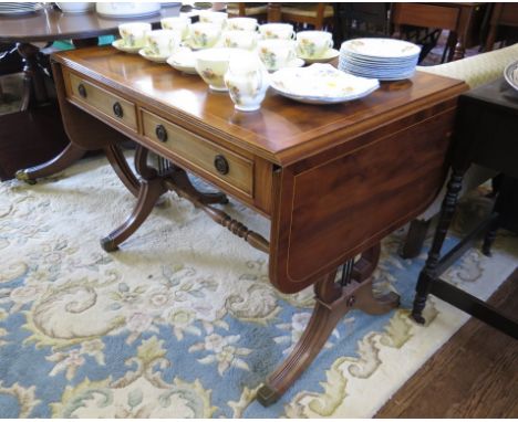 A reproduction George III style yewwood sofa table, with two frieze drawers over lyre shape supports and downswept legs with 