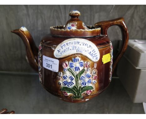 A Measham Barge Ware teapot with floral decoration and panel inscribed 'A Present to Phillis from Frank and Ada 1913' as foun