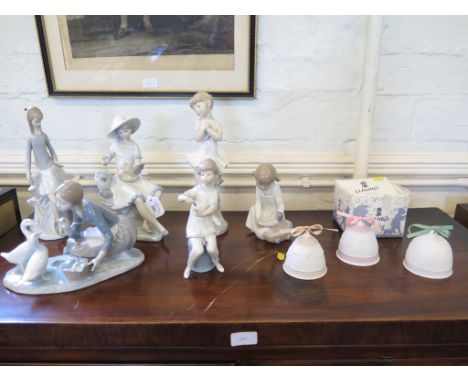 A Lladro figure of a girl painting her nails, 19cm high, another of a girl feeding geese, three Christmas bells and four othe
