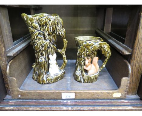 A Sylvac tree trunk form jug with a seated rabbit 24cm high, and another similar with a squirrel 15.5cm high (2)
