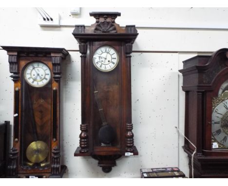 A dark wood Vienna style wall clock, two-piece enamel dial with Roman numerals and fleur-de-lys half-hour markers, matched bl