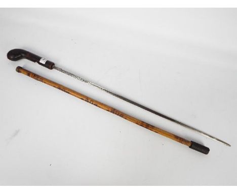 A 20th century bamboo swordstick with leather bound hilt and blade marked Toledo, approximately 68 cm blade.
