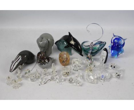 A collection of glassware comprising paperweights by Wedgwood, Langham Glass and other, Swarovski and similar models and othe