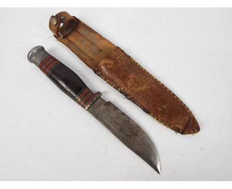 A vintage Wade &amp; Butcher Boone hunting knife in later sheath.