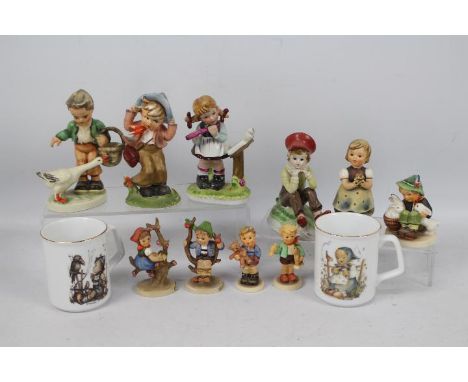 A collection of Hummel and similar figures, largest approximately 16 cm (h) and two Hummel mugs.