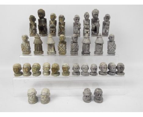 Ethnographica - An African carved stone chess set with 11 cm king.