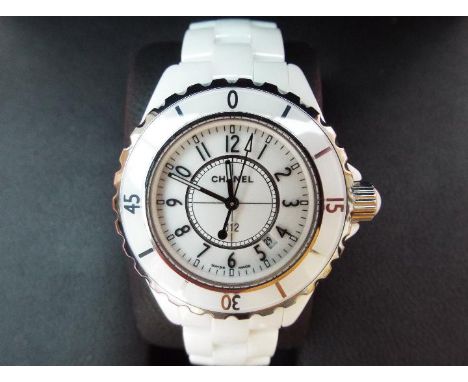 Chanel J12 - a lady's white ceramic quartz wristwatch, certificate of authenticity card states date of purchase 25/12/04 (i.e