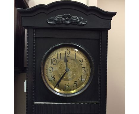 EBONISED CARVED OAK LONGCASE CLOCK
the unsigned weight driven movement striking on a gong, the 10.5 inch gilt dial with Roman