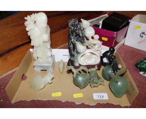 A collection of polished stone carvings to include jade coloured examples
