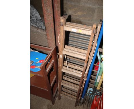 A triple extending wooden ladder