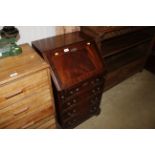 A reproduction mahogany bureau fitted four drawers