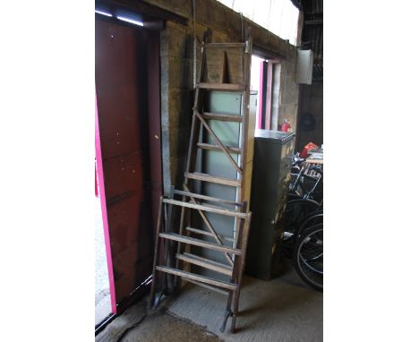 A large wooden folding step ladder, a towel rail and a clothes horse