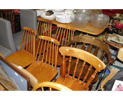 A set of four Ercol style stick back chairs; a pine spindle back chair; and an elbow chair 