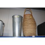 A wicker basket and galvanised vase