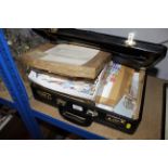 A briefcase and contents of various stamps
