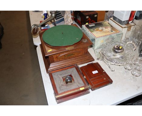 A wind up gramophone and a vintage wooden and brass mounted camera