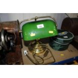 A brass desk lamp with green glass shade
