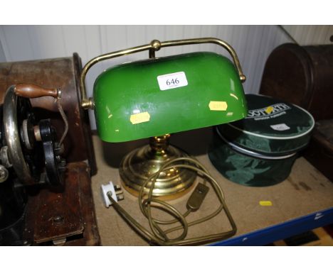 A brass desk lamp with green glass shade