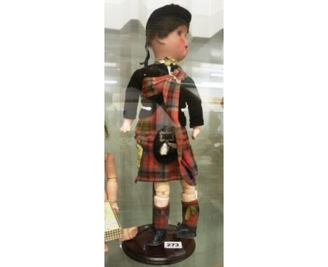 Schoenau & Hoffmeister 18" bisque headed doll in Scottish uniform on stand, some fingers broken, some rubbing, fair condition