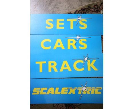Four vintage Scalextric shop advertising display cards including 'Scalextric', 'cars', 'track' and 'sets' all 7" x 23.5" appr