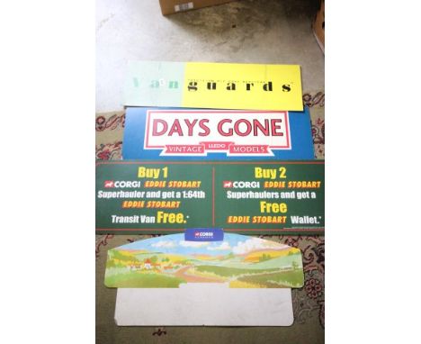 Four cardboard shop display advertising signs including Vanguards, Corgi Classics, Lledo Days Gone and Corgi Eddie Stobart al