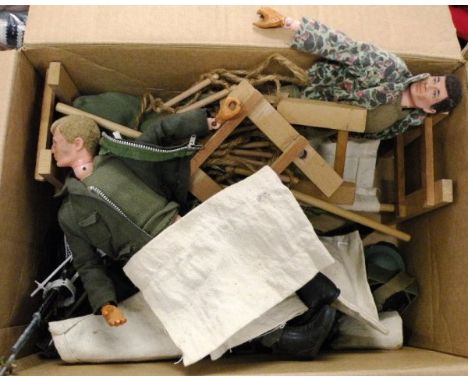 Group of vintage Action Man including two dolls (both showing wear, loose leg, damaged hands) and a quantity of weapons and a