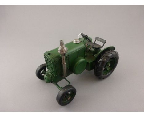 Tin plate tractor in the style of a vintage Massey Ferguson