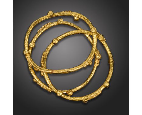 Three diamond-set gold bangles, each undulating bangle with hammered finish, with pellet decoration and set with graduated ro