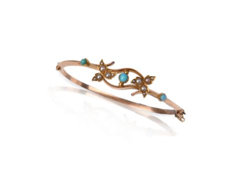 An Edwardian gold hinged bangle, set with turquoise cabochons and seed pearls