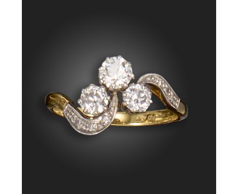 A diamond three-stone ring, set with a trefoil of graduated round brilliant-cut diamonds, set with single-cut diamonds to the