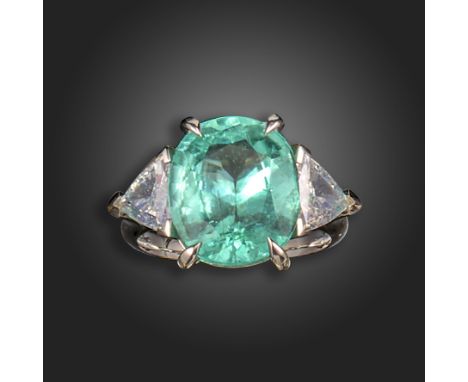 A Paraiba-type tourmaline and diamond three-stone ring, the oval-shaped tourmaline is set with a triangular-shaped diamond to