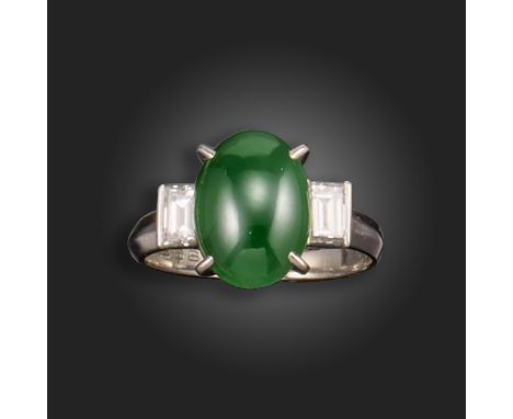 A jade and diamond three-stone ring, the jade cabochon is set with a baguette-shaped diamond to each shoulder in platinum, si