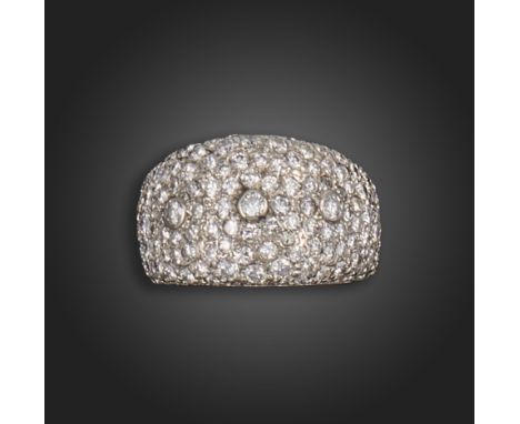 A diamond bombe ring, pave-set with round brilliant-cut diamonds, with three raised diamonds in rubover settings, set in whit