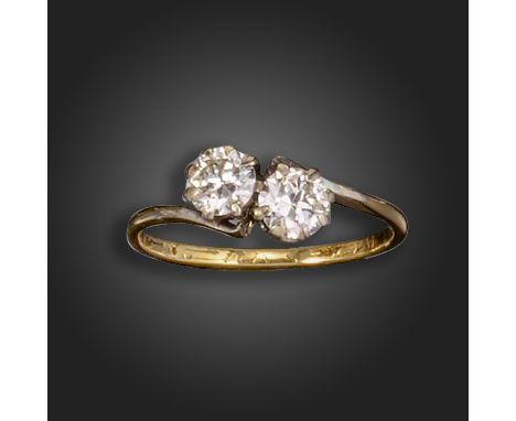 A two-stone diamond crossover ring, set with two round brilliant-cut diamonds each weighing approximately 0.47cts, with rubbe