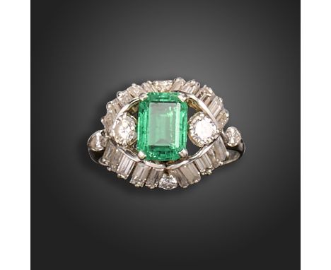 An emerald and diamond cluster ring by Boucheron, the emerald-cut emerald is set within a surround of baguette-shaped diamond